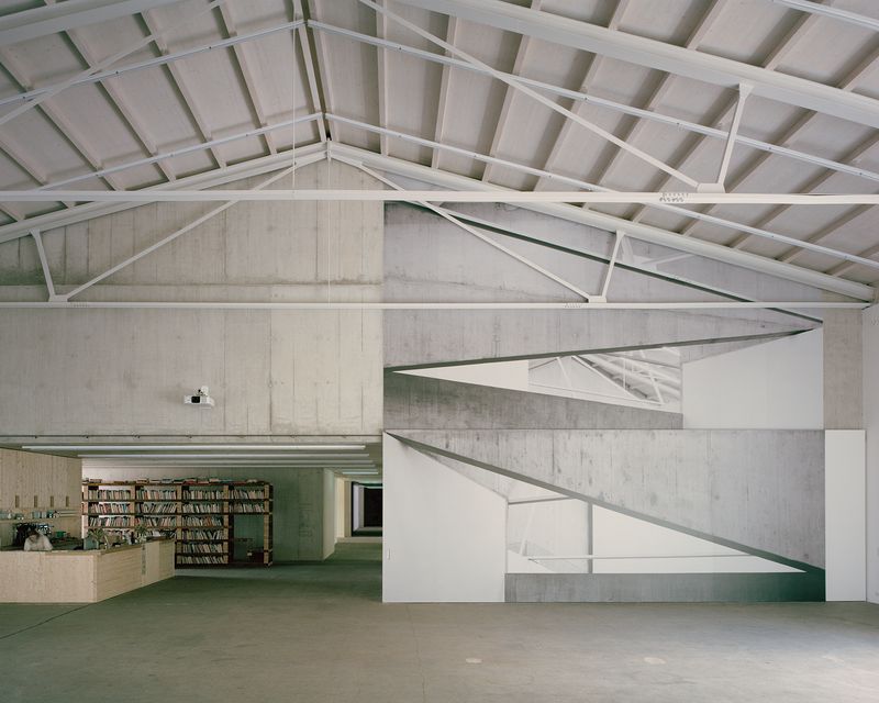 Kunsthaus Baselland – Die alten Dachbalken, die aus statischen Gründen ersetzt werden mussten, wurden umfunktioniert und als Bibliothek neben dem Foyer wiederverwendet. – Fotografie: © Rory Gardiner. Kunsthaus Baselland, ‘Rewilding’, Münchenstein / Basel, 2024.  Renate Buser, Switchback, 2024, Analoge Fotografie, digitalisiert Print auf Bodenfolie, ca. 1000 × 1000 cm