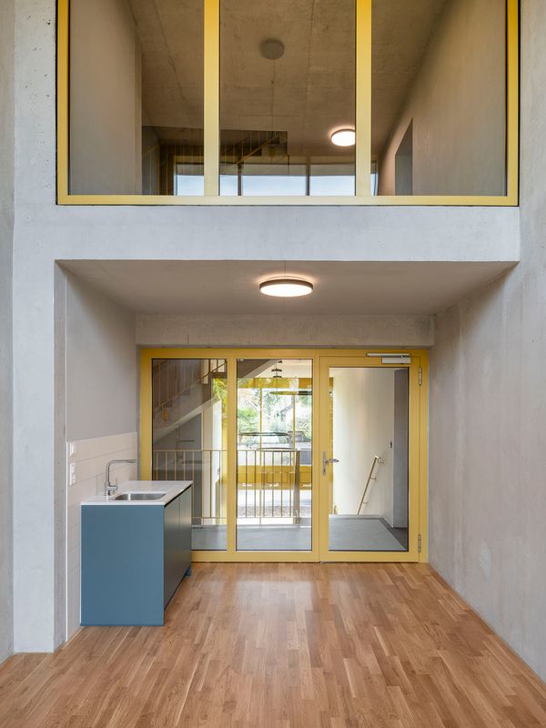 Immeuble de logements coopératifs, PSBL et PPE – Local commun sur double hauteur et accessible depuis le 1er étage – Johannes Marburg Photography